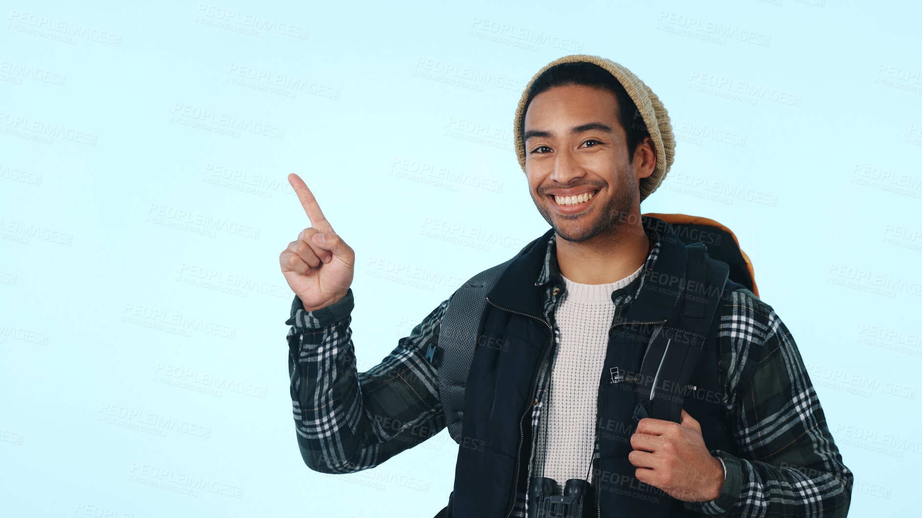 Buy stock photo Hiking, pointing or man with advertising in studio for trail event, travel marketing or promo offer. Portrait, happy hiker or show space for trekking tips, backpacker deal and info on blue background