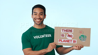 Buy stock photo Volunteer, poster and portrait of man for climate change, earth day campaign and ecology in studio. Space, happy and person with sign for awareness, global warming and recycling on blue background