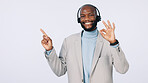 Black man, portrait or pointing with headset for business advertising on a studio background. Businessman, agent or smile with OK sign for good customer service, CRM advice or helpful tips on space