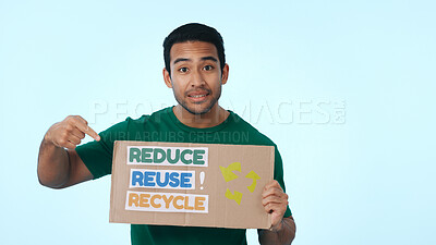 Buy stock photo Volunteer, poster and portrait of man pointing for climate change, conservation and global warming. Space, studio and person with sign for earth day, ecology and recycling campaign on blue background