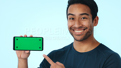 Buy stock photo Green screen, online and happy man with phone, portrait and recommendation for social media and web. Blue background, marketing and person with smile for mobile, promotion and technology in studio