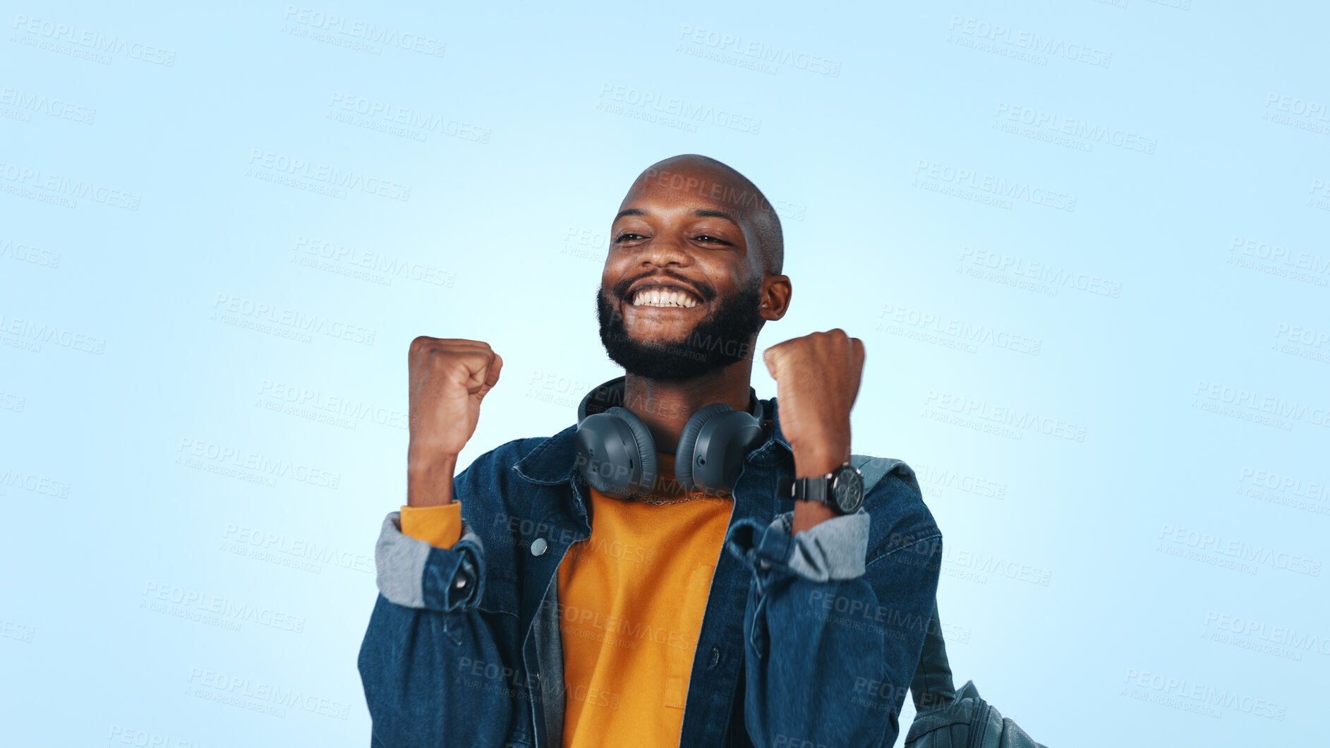 Buy stock photo Happy, black man and student winning with fist pump in studio for good news on a blue background. Excited, male person or learner with smile for achievement, accomplishment or celebration on space