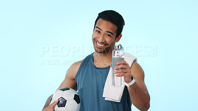 Buy stock photo Soccer, happy and portrait of man in studio for exercise, tournament and training for sports. Space, athlete and person with ball, towel and water for wellness, health or hydration on blue background