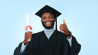 Buy stock photo Graduation, black man or portrait of student with thumbs up in studio for diploma on a blue background. Male person, graduate or smile with like emoji, success or certificate for academic achievement
