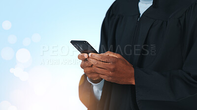 Buy stock photo Phone, hands and man in studio for graduation with notification, email or contact for college results. Technology, bokeh and male graduate on mobile app for university ceremony by blue background.