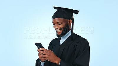 Buy stock photo Happy, black man and graduation with phone in studio for online scholarship on a blue background. Male person, graduate or student with smile, mobile smartphone or app for academic results on space