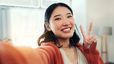 Buy stock photo Happy woman, portrait and selfie with peace sign in home, profile picture or memory for social media. Influencer, online and Asian person with smile for image, photography and vlog with gesture