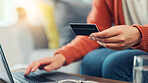 Credit card, laptop and hands of woman on sofa for online shopping, digital subscription or internet payment. Home, ecommerce and person with bank info on computer for purchase, transaction and sale