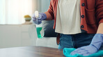 Clean, table and hands with spray in house, housekeeping and disinfection with chemical for bacteria. Home, chores and person with liquid for sanitation, wipe or cleaner with disinfectant for hygiene