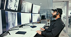 Security guard, man and computer in control room, inspection for video surveillance agency. Employee, officer and person in workplace, pc and monitor for building protection, camera and footage
