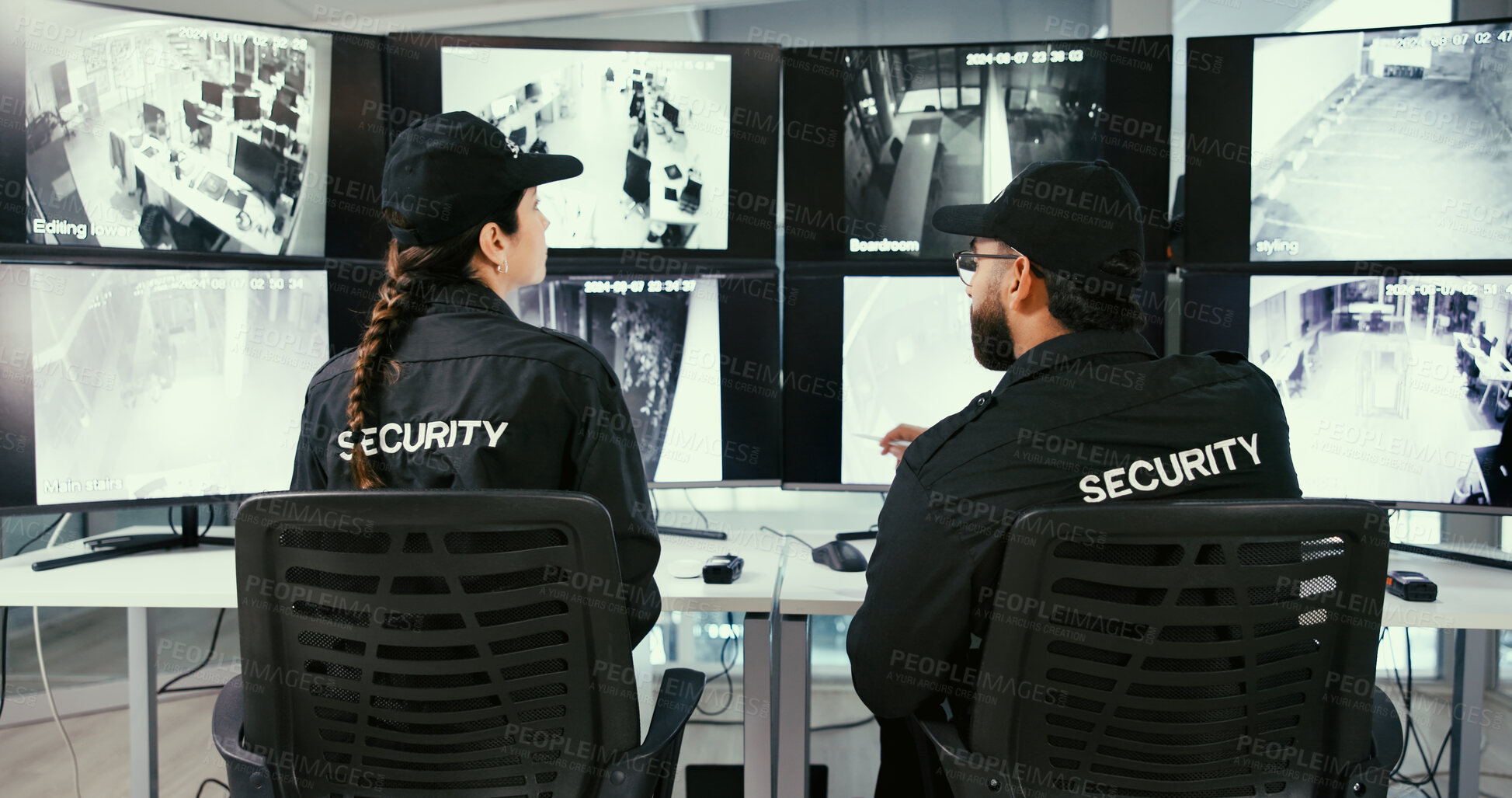 Buy stock photo Back, people and security guard in control room for video surveillance, collaboration or safety plan. Law enforcement, officer and team in workplace for crime prevention, monitor CCTV and discussion.