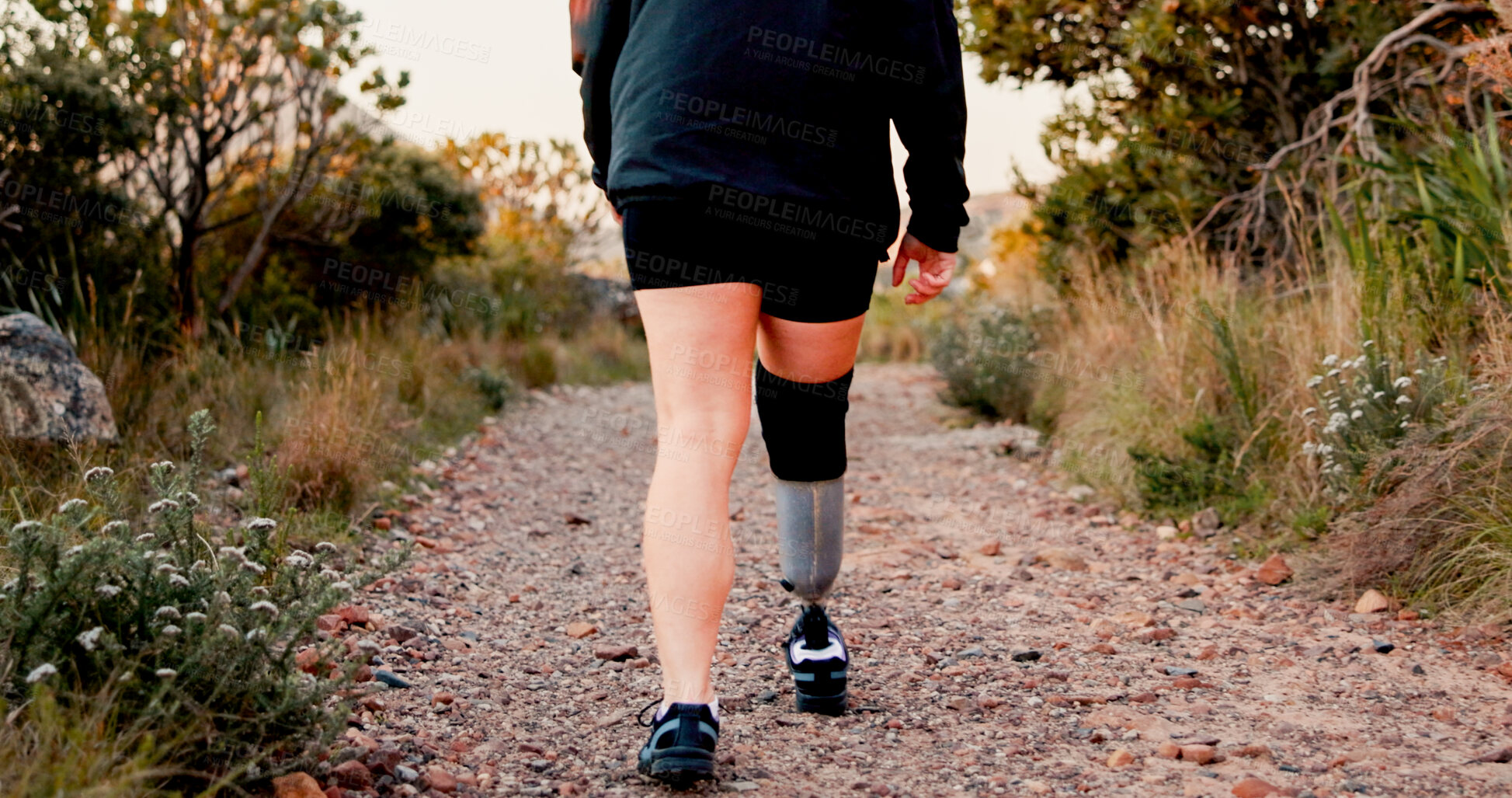 Buy stock photo Legs, athlete and prosthetic limb for hiking with exercise, workout and health benefits. Prosthesis, fitness and person with disability outdoor for adventure, hobby and rehabilitation in Canada