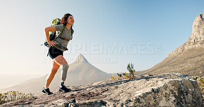 Buy stock photo Happy woman, hiking and backpack with prosthetic leg on mountain rock for outdoor exercise. Hiker, journey or female person with a disability on cliff for trekking adventure, trip or walk in nature