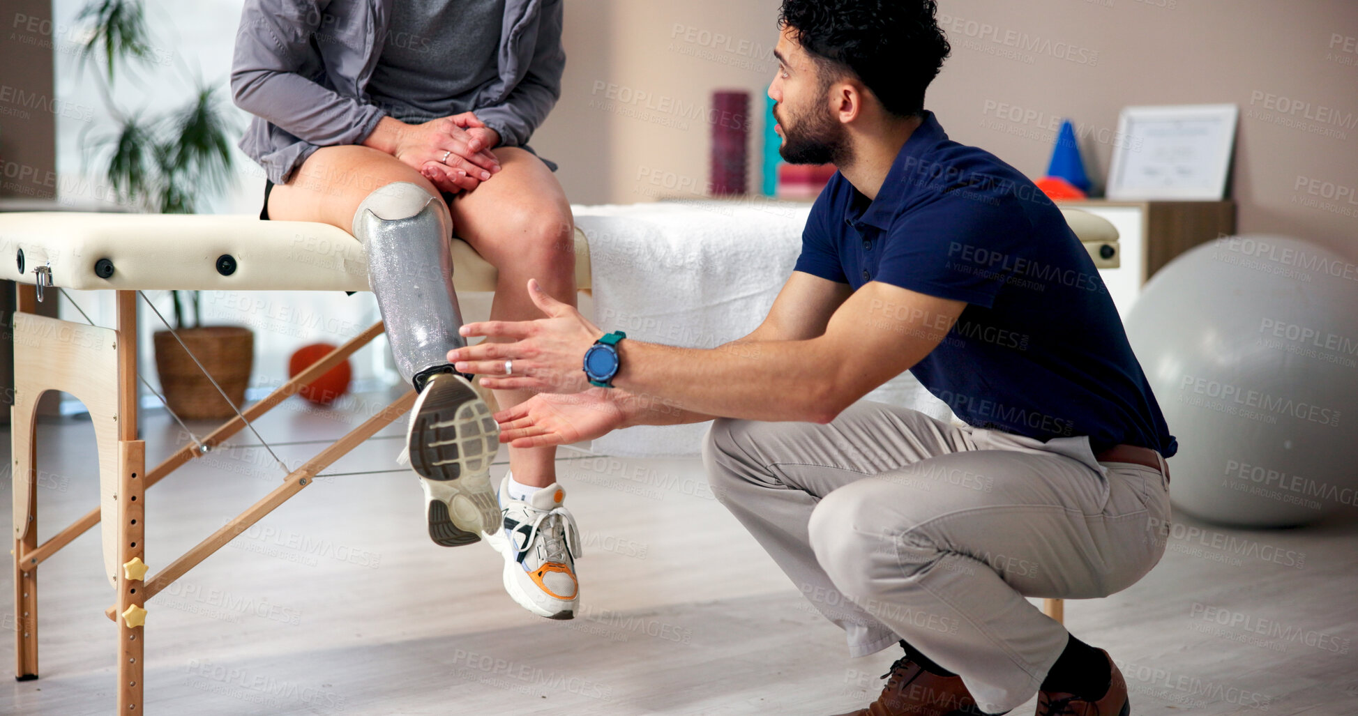 Buy stock photo Physiotherapist, leg and person with amputee, talking and people with rehabilitation. Healthcare, conversation or consultation for medical prosthetic, physical therapy or man with woman in clinic