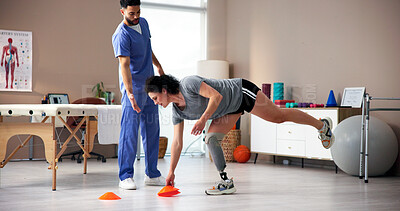 Buy stock photo Physiotherapist, patient or disc with cones on prosthetic leg for mobility training or balance in clinic. Doctor, done and helping person with a disability on obstacles for rehabilitation or aid