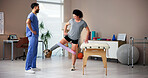 Physiotherapist, resistance band and exercise with prosthetic leg for workout or mobility in clinic. Doctor, patient or helping person with a disability for physical training, balance or flexibility