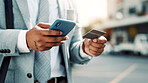 Businessman, hands and credit card with phone in city for online shopping or mobile banking app. Man, user or shopper with smartphone or debit for ecommerce, payment or wireless transaction in town