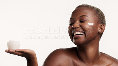 Buy stock photo Cream, skincare and black woman in studio, smile and dermatology on white background. Space, container and African person with happiness, creme and facial lotion for healthy skin, shine and cosmetics