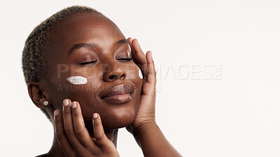 Buy stock photo Skincare, beauty and black woman in studio with face cream, retinol or collagen for antiaging benefits. Person, lotion and moisturizer for dermatology, clear skin or mockup space on white background.