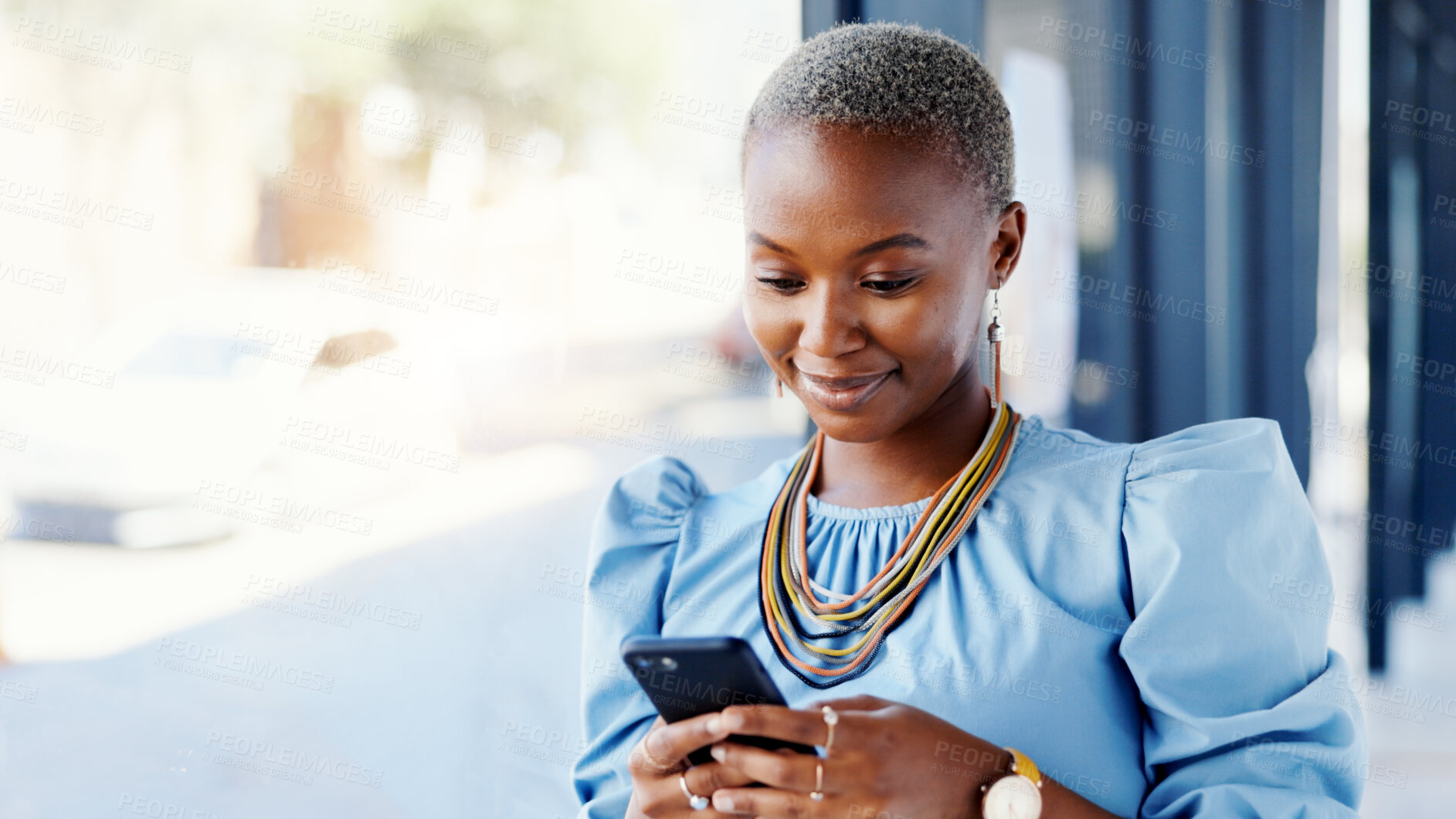 Buy stock photo Phone, smile and black woman in office with texting, email or contact for creative project feedback. Happy, typing and African female magazine editor with cellphone for article review on mobile app.