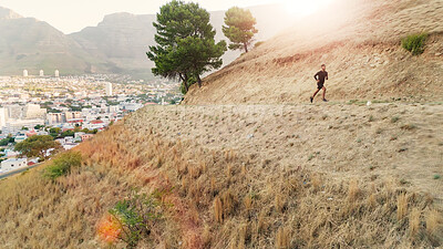 Buy stock photo Man, running and exercise in nature for fitness, leg muscle development and training for cardio. Male person, runner and jogging on mountain trail for healthy body, outdoor challenge and wellness