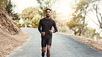 Man, running and earphones in nature for fitness, leg muscle development and training with podcast. Male person, runner and audio technology on pathway for healthy body, outdoor challenge and music