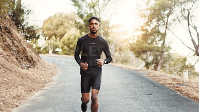 Buy stock photo Man, running and earphones on mountain road for fitness, cardio development and training with podcast. Male person, runner and audio tech in nature for healthy body, outdoor challenge and music