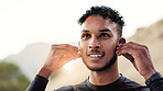 Fitness, music and thinking with man outdoor for start of cardio training or workout routine. Earphones, exercise and vision with happy runner in nature for challenge, physical activity or wellness