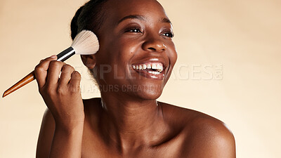 Buy stock photo Happy, makeup and black woman with brush for beauty, blush or highlighter with glow. Smile, self care and female person with cosmetic tool and foundation for face cosmetology by studio background.