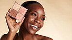 Beauty, makeup and color palette with black woman in studio for cosmetics, powder and glow. Eyeshadow, foundation and space with African person for cosmetology, aesthetic or blush on background