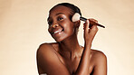 Brush, makeup and portrait of black woman in studio with beauty, blush or foundation with facial glow. Happy, cosmetics and African female person with tool for face cosmetology by white background.