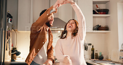 Buy stock photo Laugh, dance and couple in kitchen for love, anniversary celebration or happiness with partner. Spin, funny woman and man in home with music, holding hands or romantic rhythm for healthy relationship
