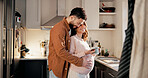 Hug, couple or pregnant woman with coffee cup in kitchen, connection or affection for family growth. Phone, embrace or happy people with tummy touch for bonding, maternity support or beverage in home