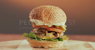 Buy stock photo Beef, burger and fast food in restaurant for takeaway order, lunch or catering service for hospitality. Delicious, meal and vegetables on wooden board with meat, lettuce and tomato for tasty dish.
