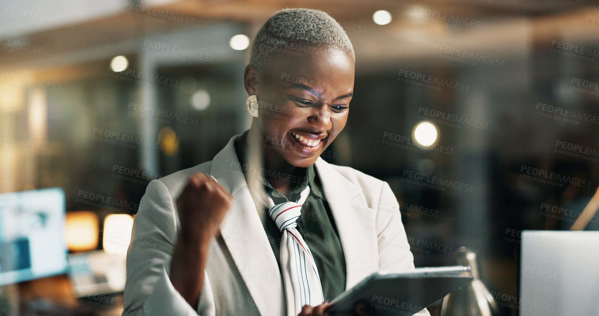 Buy stock photo Happy, black woman and winning with tablet at night for promotion or business success in office. Excited, female person or working late with smile or technology for bonus or good news in workplace