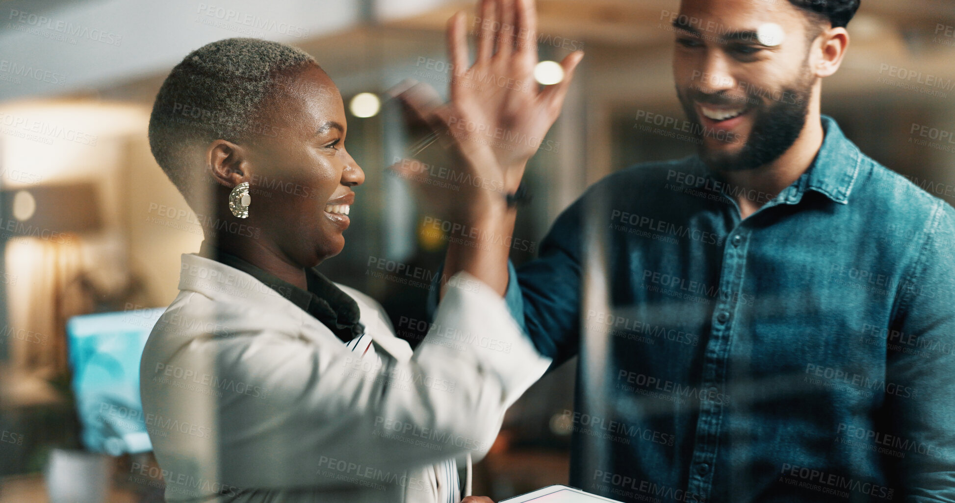 Buy stock photo Happy people, night and business with high five in office for teamwork or deadline success. Businessman, woman or colleagues working late with smile for achievement, promotion or winning together
