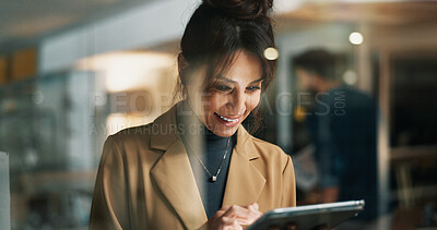 Buy stock photo Woman, tablet and smile at window at startup for review, night and feedback for article at company. Person, happy and editor with solution by glass on tech, proposal or application at media agency