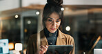 Night, reading or woman with tablet in office, publishing deadline or review story for digital media site. Glass, tech or mature journalist with grammar check app, news article editing or overtime