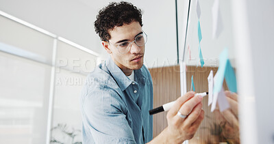 Buy stock photo Man, writing or planning with glass board in office for schedule, tasks or project agenda. Male person, employee or brainstorming with sticky note or marker for reminder, ideas or work strategy