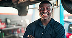Black man, portrait and mechanic with confidence in garage for automotive service, fix or repair. Male person, African engineer or smile with pride, vehicle or car on platform for machine maintenance