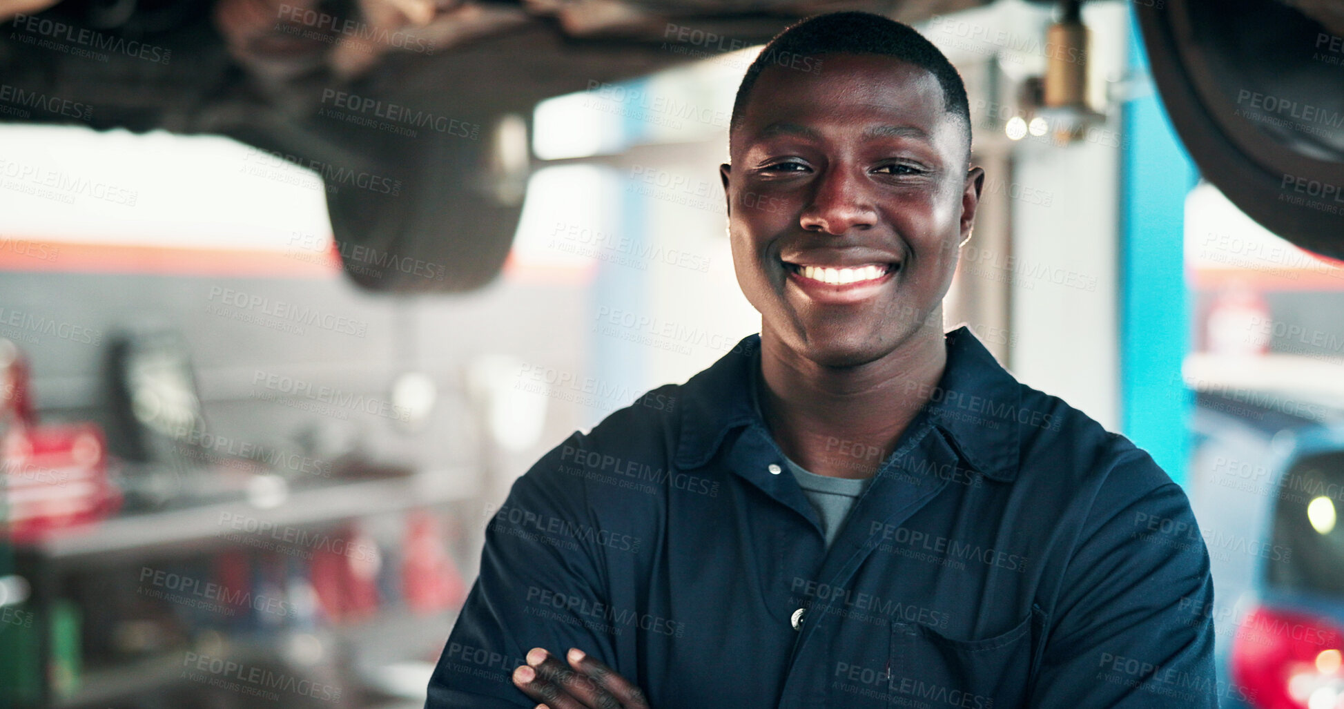 Buy stock photo Black man, portrait and mechanic with confidence in garage for automotive service, fix or repair. Male person, African engineer or smile with pride, vehicle or car on platform for machine maintenance