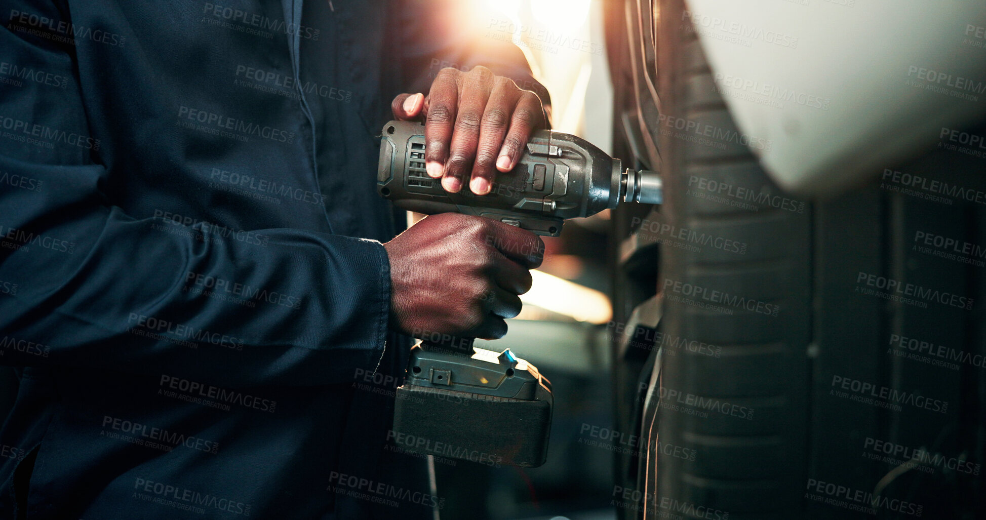 Buy stock photo Man, hands and mechanic with power tool on tire for wheel change, repair or fix in workshop. Male person, engineer or technician with equipment for bolts, vehicle maintenance or car calibration test