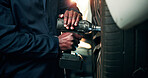 Man, hands and car mechanic with power tool on tire for wheel change, repair or fix in workshop. Male person, engineer or technician with equipment for bolts, vehicle maintenance or calibration test