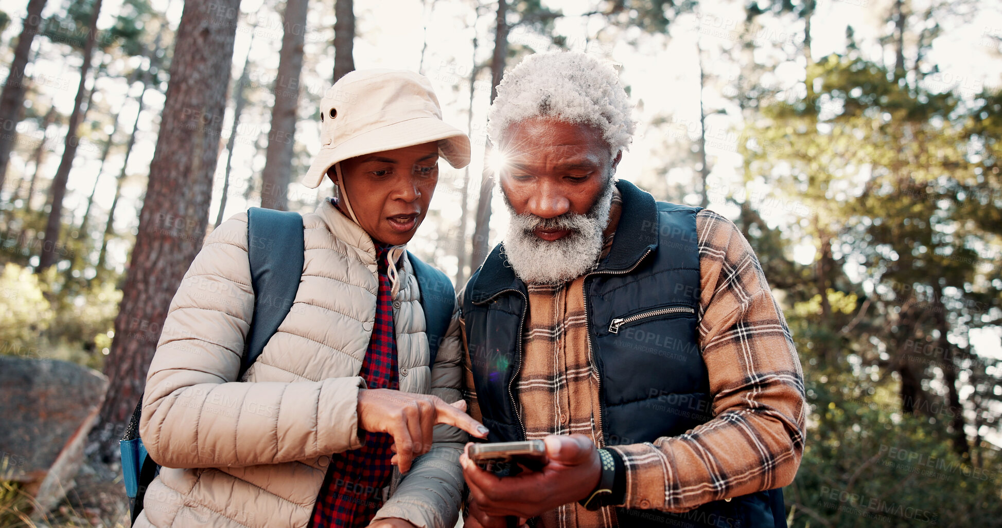 Buy stock photo Backpacking, old couple and direction with smartphone in woods, adventure or trail search on website. Outdoor, senior hiker and black people with digital map on holiday, low angle and travel together