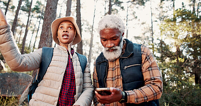 Buy stock photo Hiking, old couple and lost with smartphone in woods, talking and searching for location on website. Outdoor, senior hiker and black people with digital map on holiday, low angle and travel together