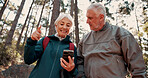 Hiking, old couple and happy with smartphone for direction, talk and search for shortcut on website. Outdoor, backpacker and elderly people with mobile for digital map, low angle and travel together