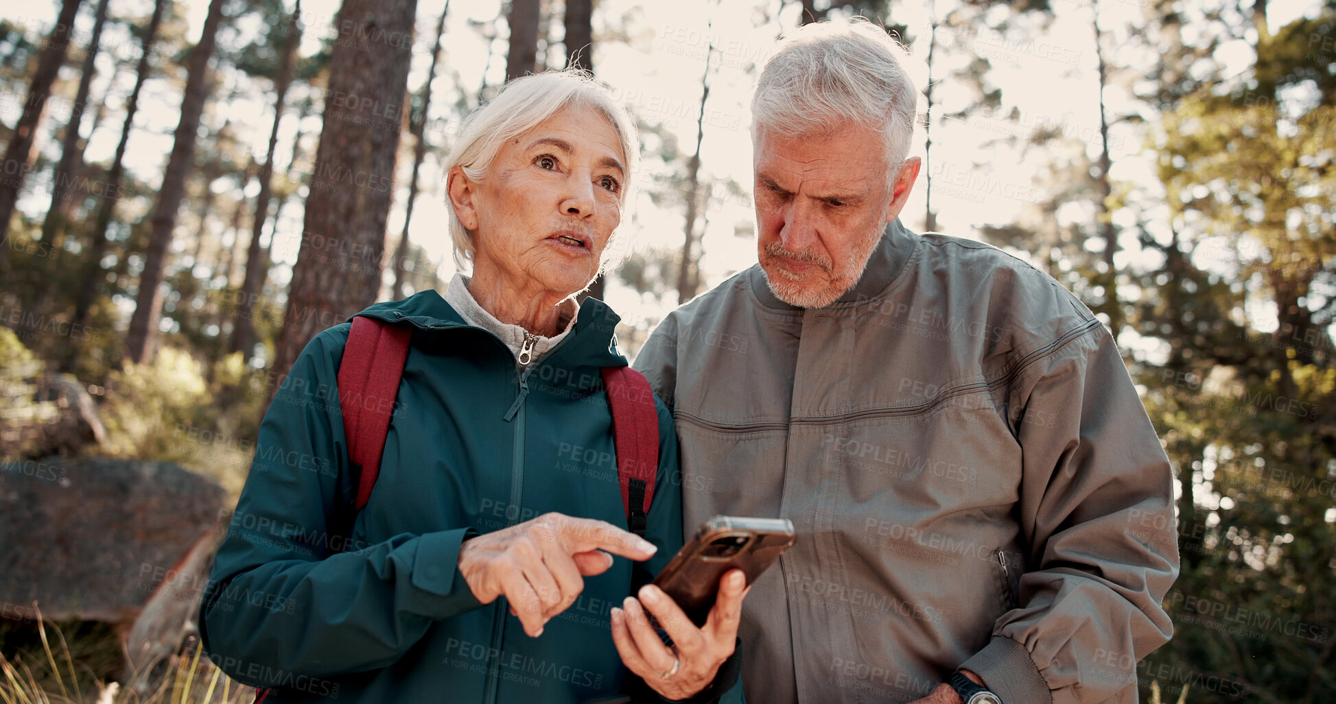 Buy stock photo Hiking, old couple and talking with smartphone in woods, lost and searching for location on website. Outdoor, backpacker and elderly people with digital map on holiday, low angle and travel together