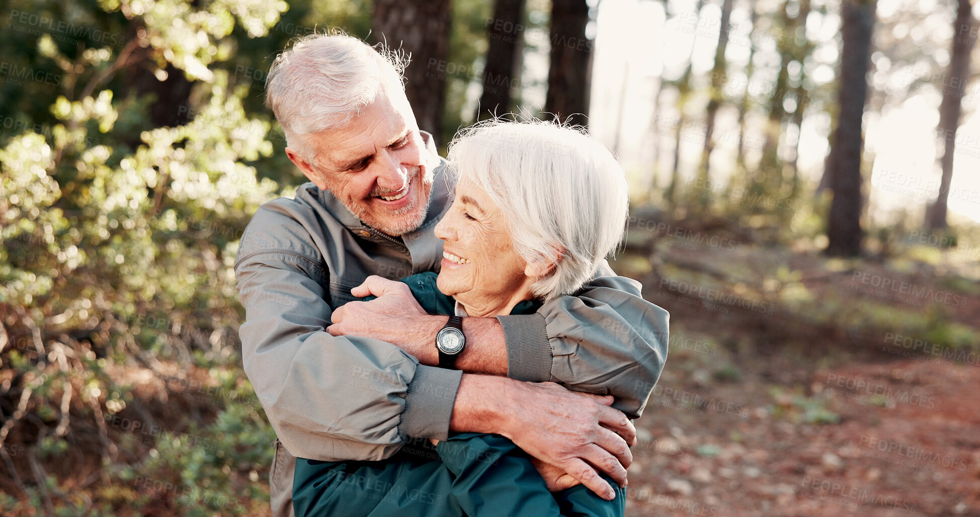 Buy stock photo Smile, old couple and hug with hiking in woods for health with vacation, trip or sightseeing. Mature man, woman and retirement with embrace for bonding, love or care for forest and holiday exercise