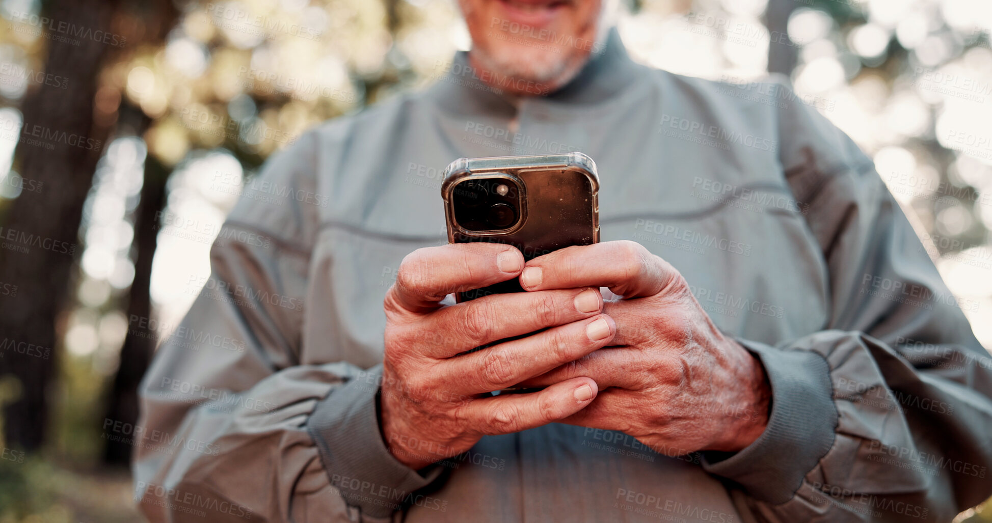Buy stock photo Hiking, phone and hands of old man in forest for wellness, fresh air and online for direction. Travel, morning and elderly person on nature trail for adventure, health and exercise on smartphone