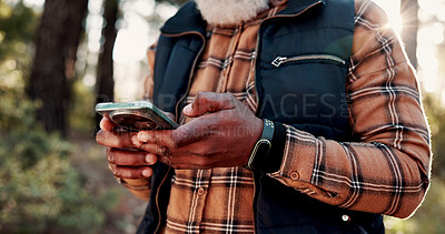 Buy stock photo Hiking, phone and hands of old man in nature for wellness, fresh air and online for direction. Travel, typing and elderly person on smartphone for mobile app, health and exercise on outdoor trail